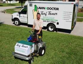 lawn care fertilization equipment and truck on grass